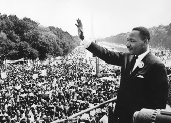 Martin Luther King, Jr. waves at crowd